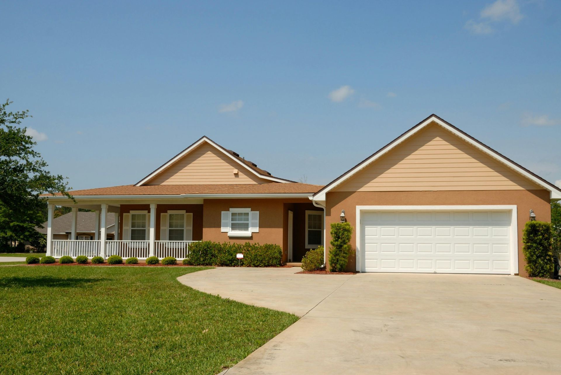 Beautiful modern suburban house with a spacious driveway and green lawn, perfect for families.